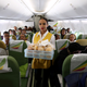 FILE PHOTO: Flight attendant serves passengers with breakfast inside Ethiopian Airlines ET314 flight to Eritrea's capital Asmara, from Addis Ababa